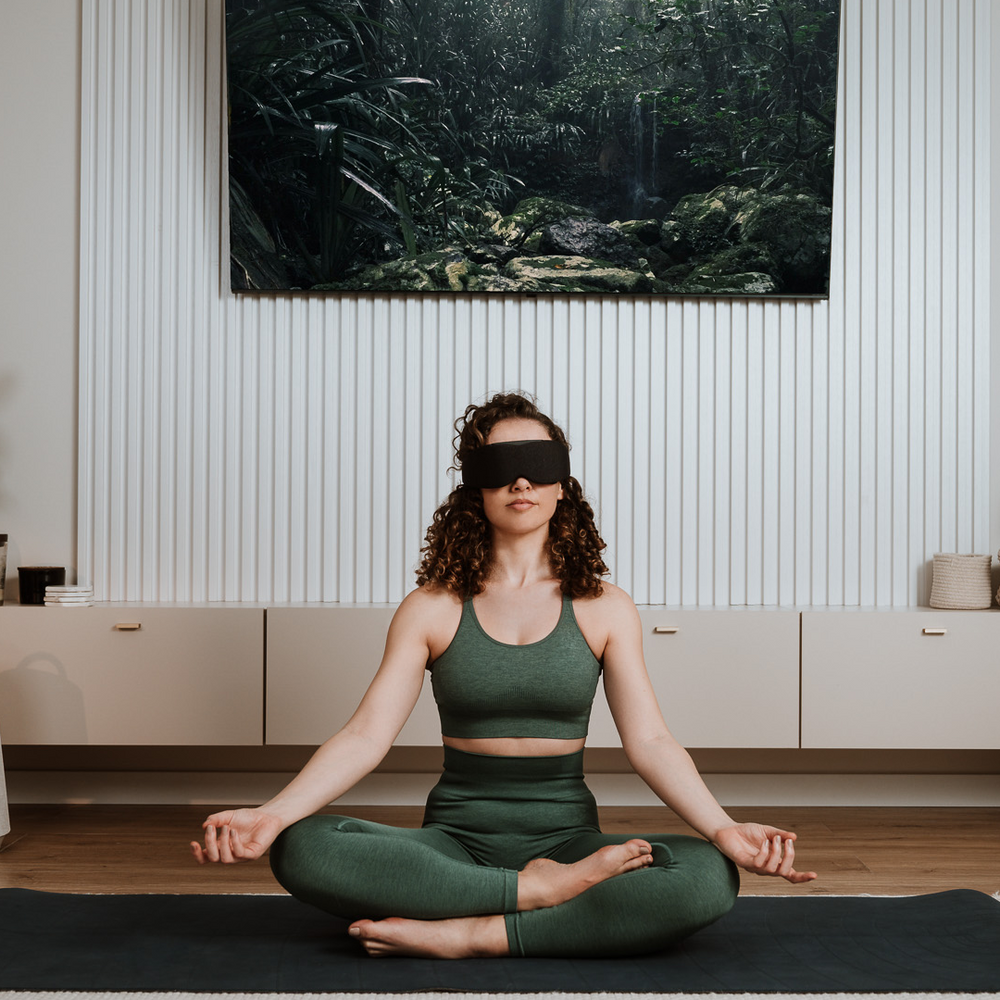 
                      
                        Woman meditating while wearing Midnight Black Aura Smart Sleep Mask in a peaceful indoor setting
                      
                    